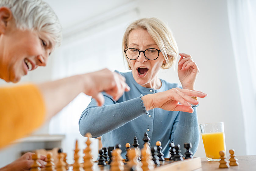 Two senior mature women caucasian female woman friends sisters play Two senior mature women caucasian female woman friends sisters play