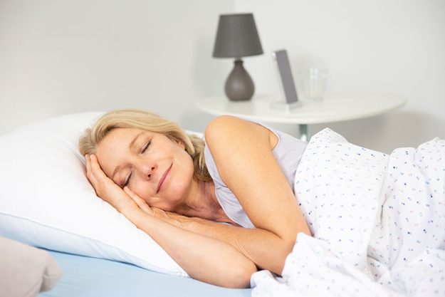 Woman sleeping her bed Woman sleeping her bed