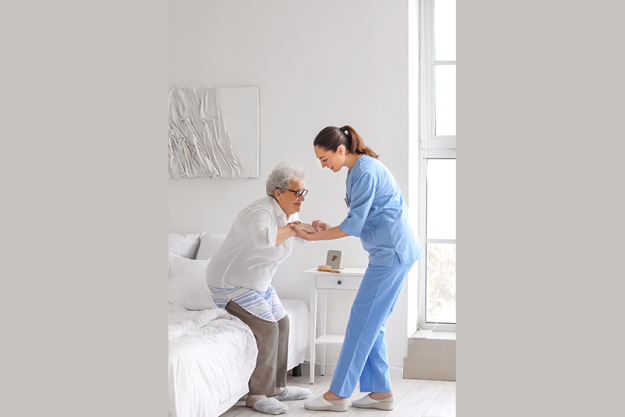 young caregiver helping senior woman young caregiver helping senior woman