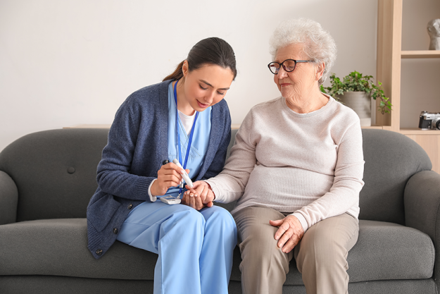 young caregiver measuring sugar level young caregiver measuring sugar level