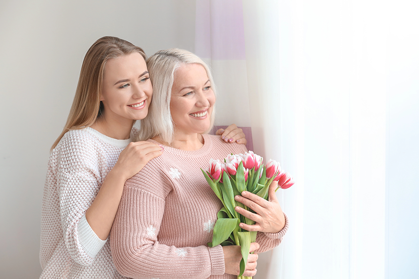 young daughter and mother with bouquet of flowers young daughter and mother with bouquet of flowers