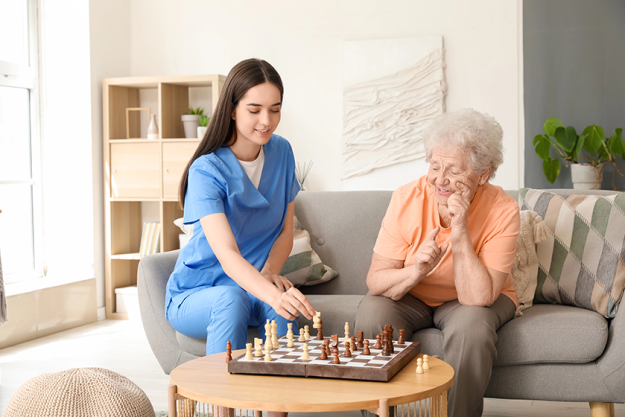 young nurse senior woman playing chess