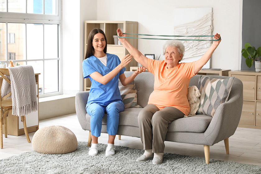 young nurse senior woman stretching band training young nurse senior woman stretching band training