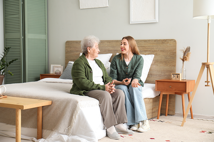 young woman her grandmother sitting bedroom young woman her grandmother sitting bedroom