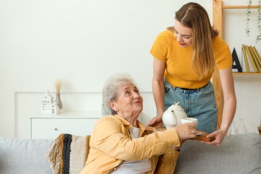 young woman her grandmother tea