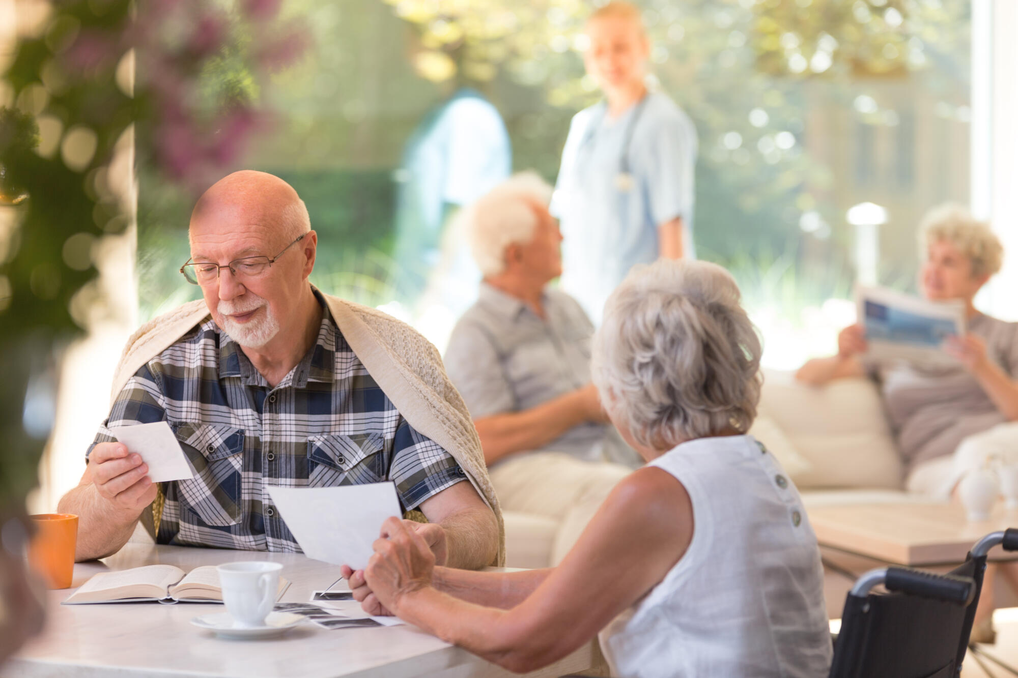 Older,Man,In,Glasses,Sitting,With,His,Female,Friend,By