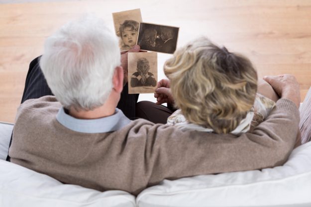 Senior,Marriage,Sitting,On,The,Sofa,And,Looking,At,Old Senior,Marriage,Sitting,On,The,Sofa,And,Looking,At,Old