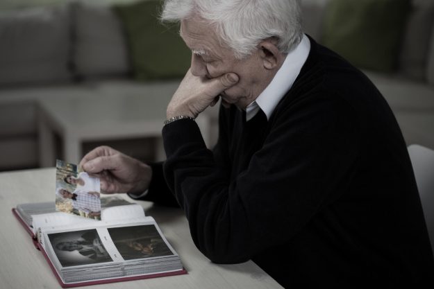 Widower,Looking,At,The,Photos,And,Remembering,Deceased,Wife