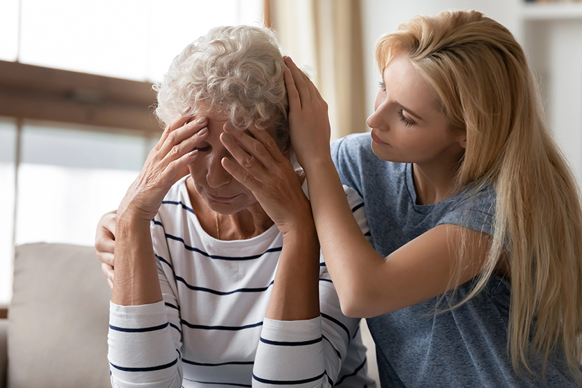 affectionate millennial girl caressing gently hair of sad retired mom