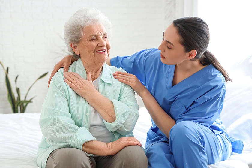 physical therapist hugging senior woman