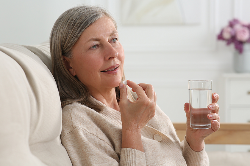 senior woman glass water taking pill senior woman glass water taking pill