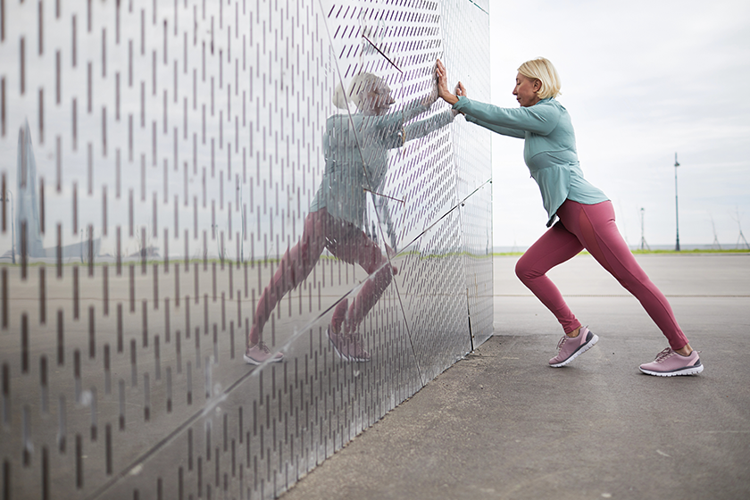 side view mature active blonde female leaning wall side view mature active blonde female leaning wall