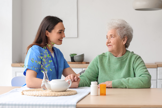 young caregiver senior woman holding hands young caregiver senior woman holding hands