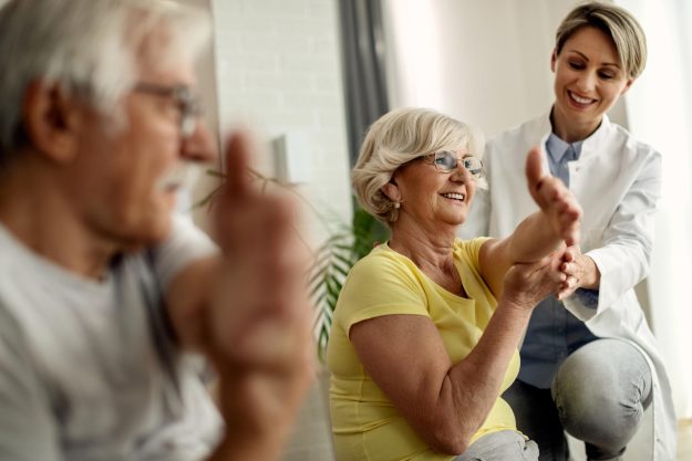 Happy,Senior,Woman,And,Her,Husband,Doing,Stretching,Exercises,With Happy,Senior,Woman,And,Her,Husband,Doing,Stretching,Exercises,With