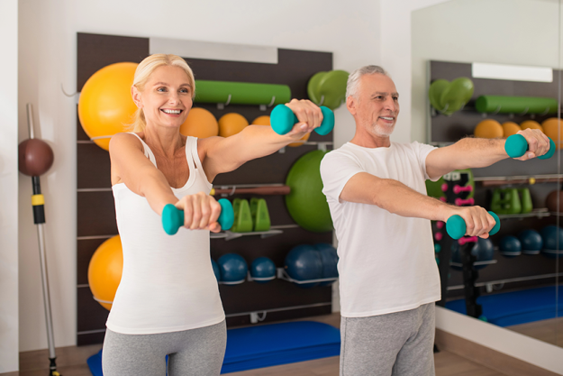 a man and a woman exercising with dumbbells a man and a woman exercising with dumbbells