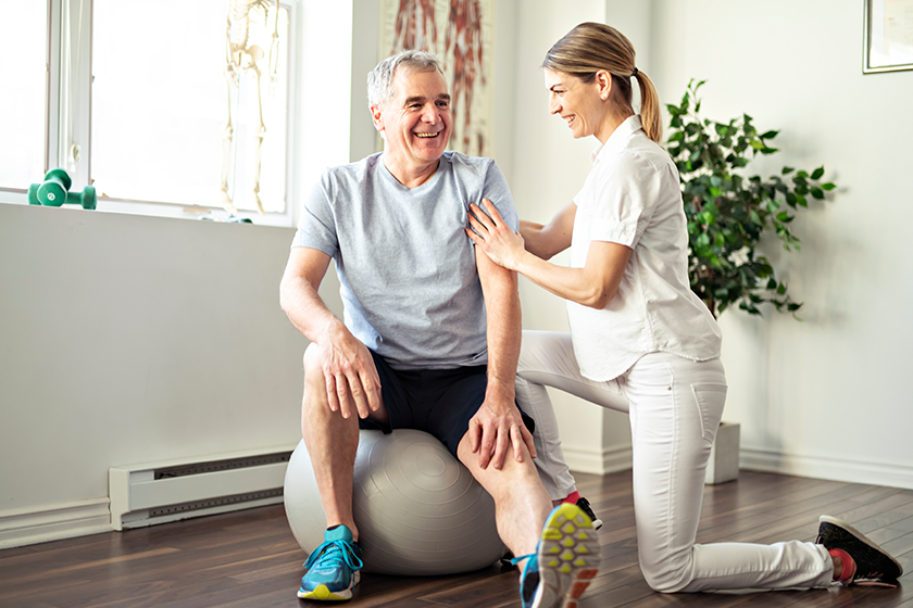 a modern rehabilitation physiotherapy worker with senior client