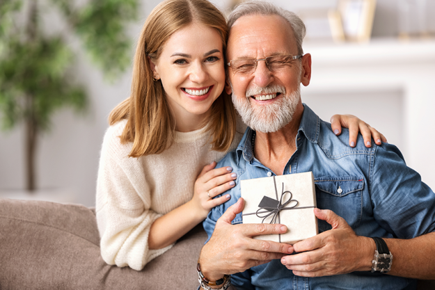 cheerful young woman hugging senior man cheerful young woman hugging senior man