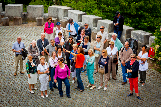group of tourists listening to the guide group of tourists listening to the guide