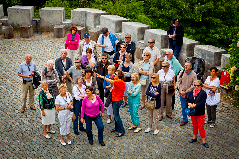 group of tourists listening to the guide