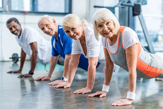 happy senior multicultural sportspeople doing plank