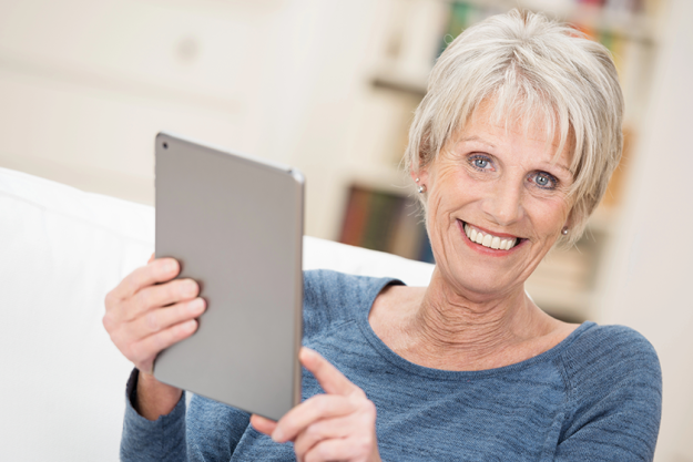 happy senior woman holding a tablet happy senior woman holding a tablet