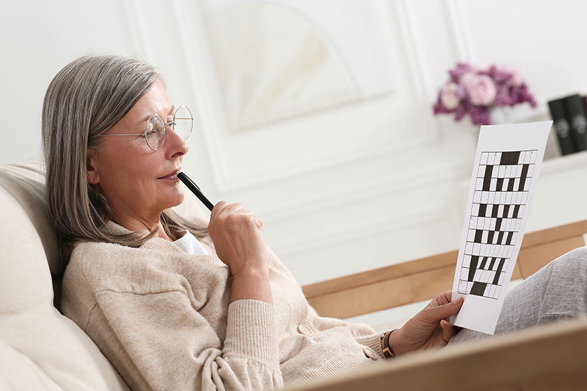 senior woman solving crossword