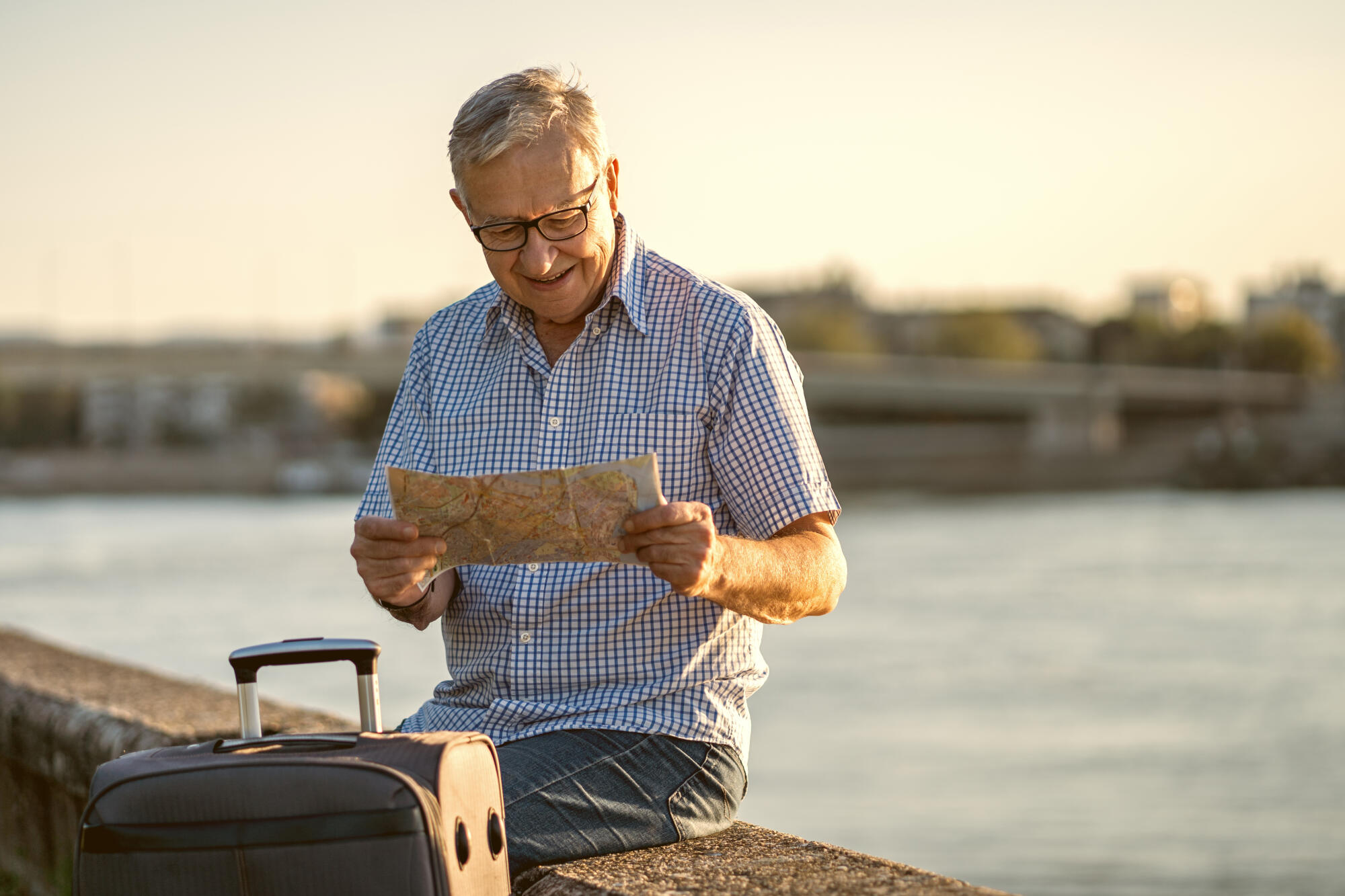 Senior man reading a map outsi