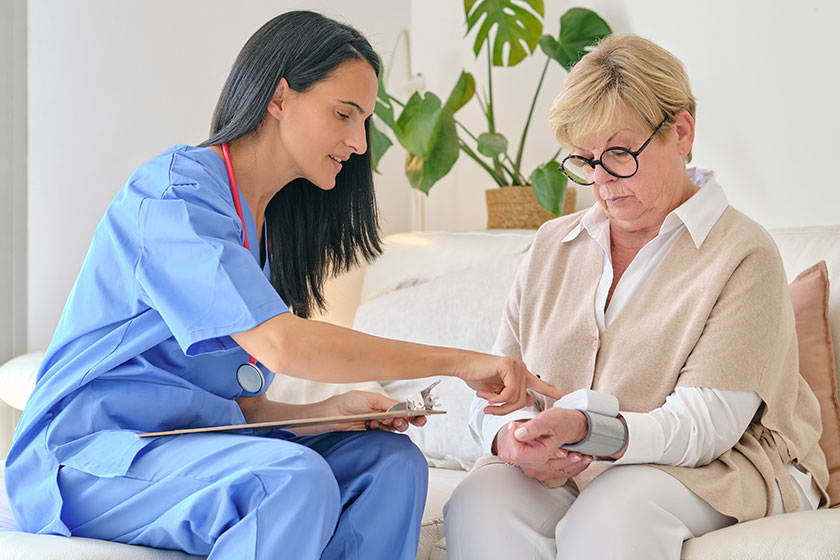 Female doctor uniform checking pulse rate digital device wrist elderly Female doctor uniform checking pulse rate digital device wrist elderly