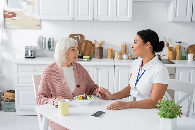 retired woman grey hair holding hands