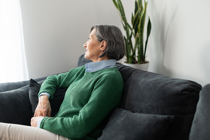 worried senior lady is looking in the window worried senior lady is looking in the window