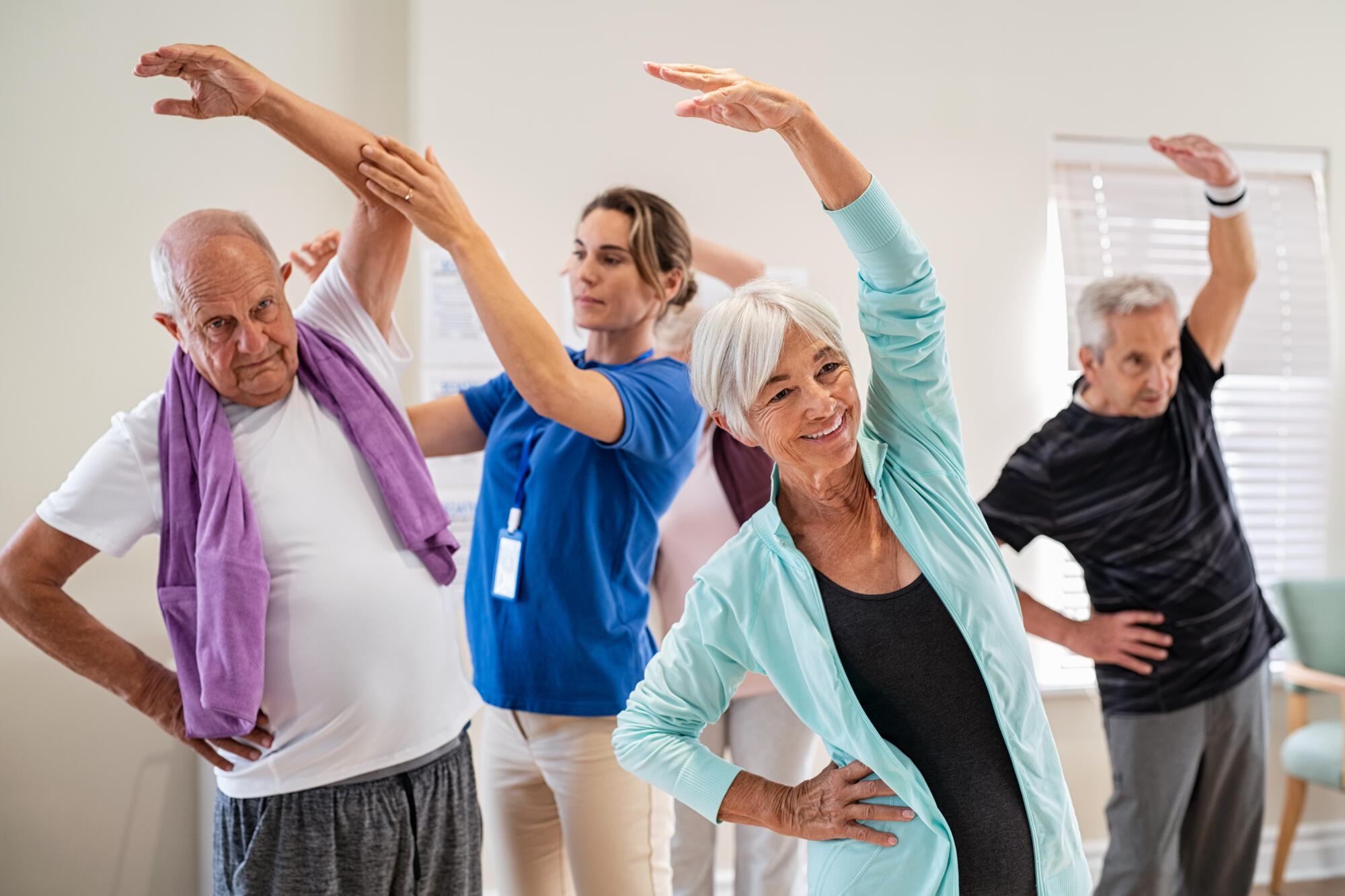 Active,Seniors,Doing,Exercise,With,Physiotherapist,At,Nursing,Home,Gym. Active,Seniors,Doing,Exercise,With,Physiotherapist,At,Nursing,Home,Gym.