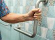 Asian elderly woman use bathroom handle security in toilet, heal