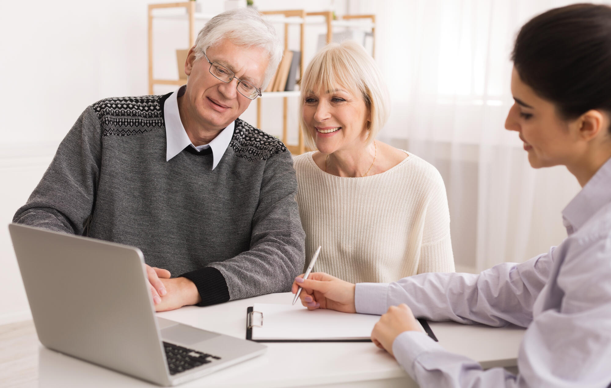 Older couple considering new home purchase looking at laptop Older couple considering new home purchase looking at laptop