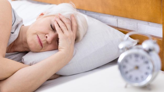 SEnior woman suffering from insomnia in bed