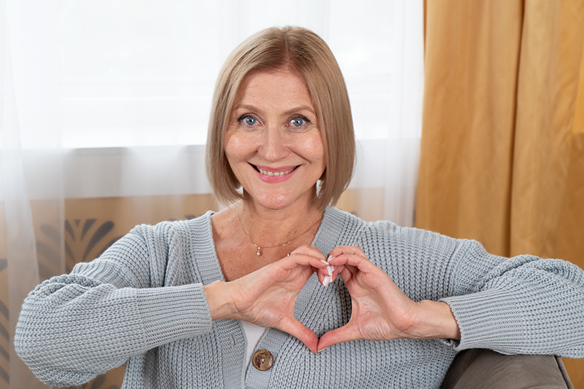 blond senior woman relaxing woman heart