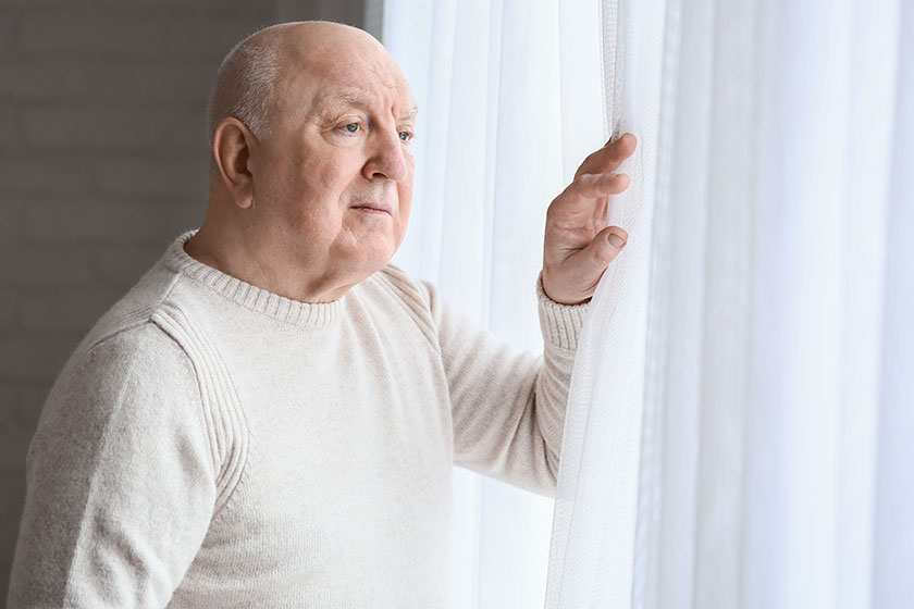 Elderly man suffering mental disability window home