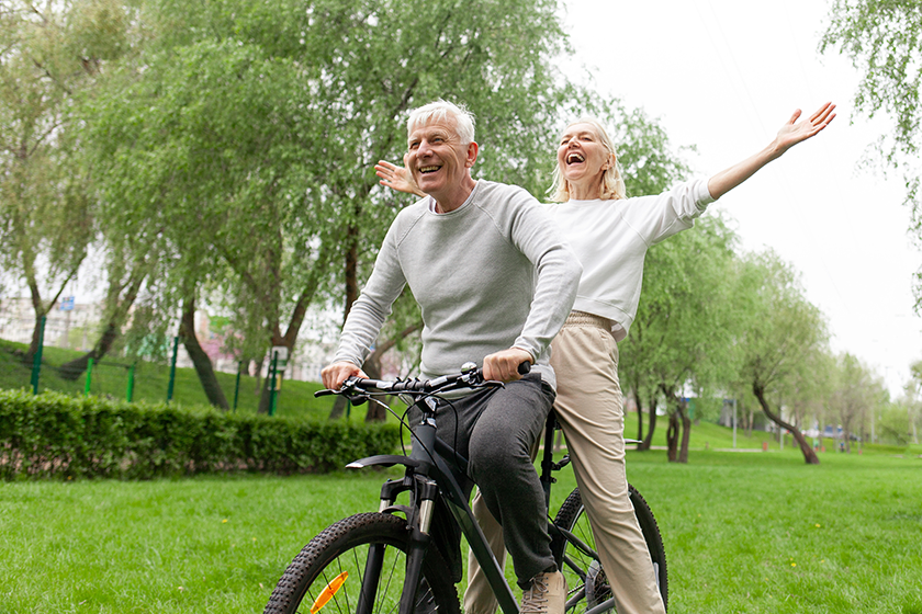 elderly senior couple riding bicycle