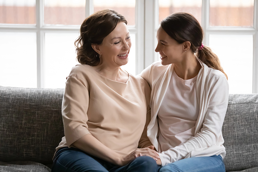 happy middle aged mother and grownup daughter