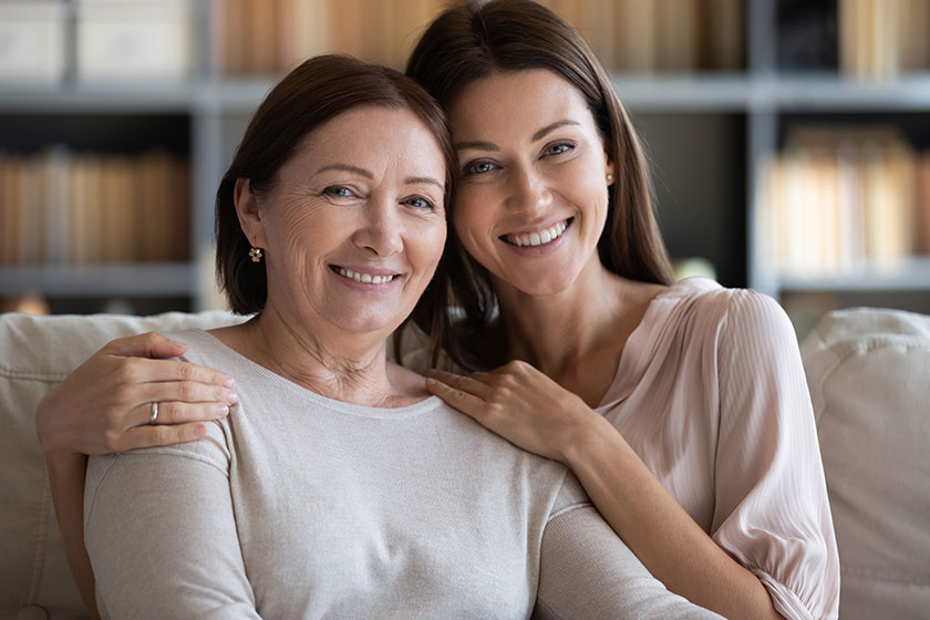 Head shot portrait mature mother and daughter hugging at home Head shot portrait mature mother and daughter hugging at home