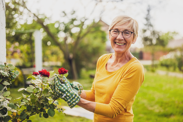 portrait happy senior woman gardening