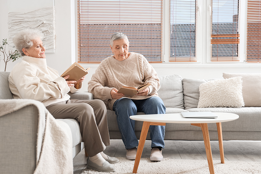 senior female friends reading books