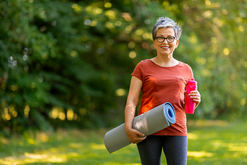 smiling senior woman holding water bottle