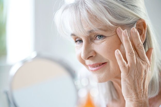 woman applying anti aging cream woman applying anti aging cream