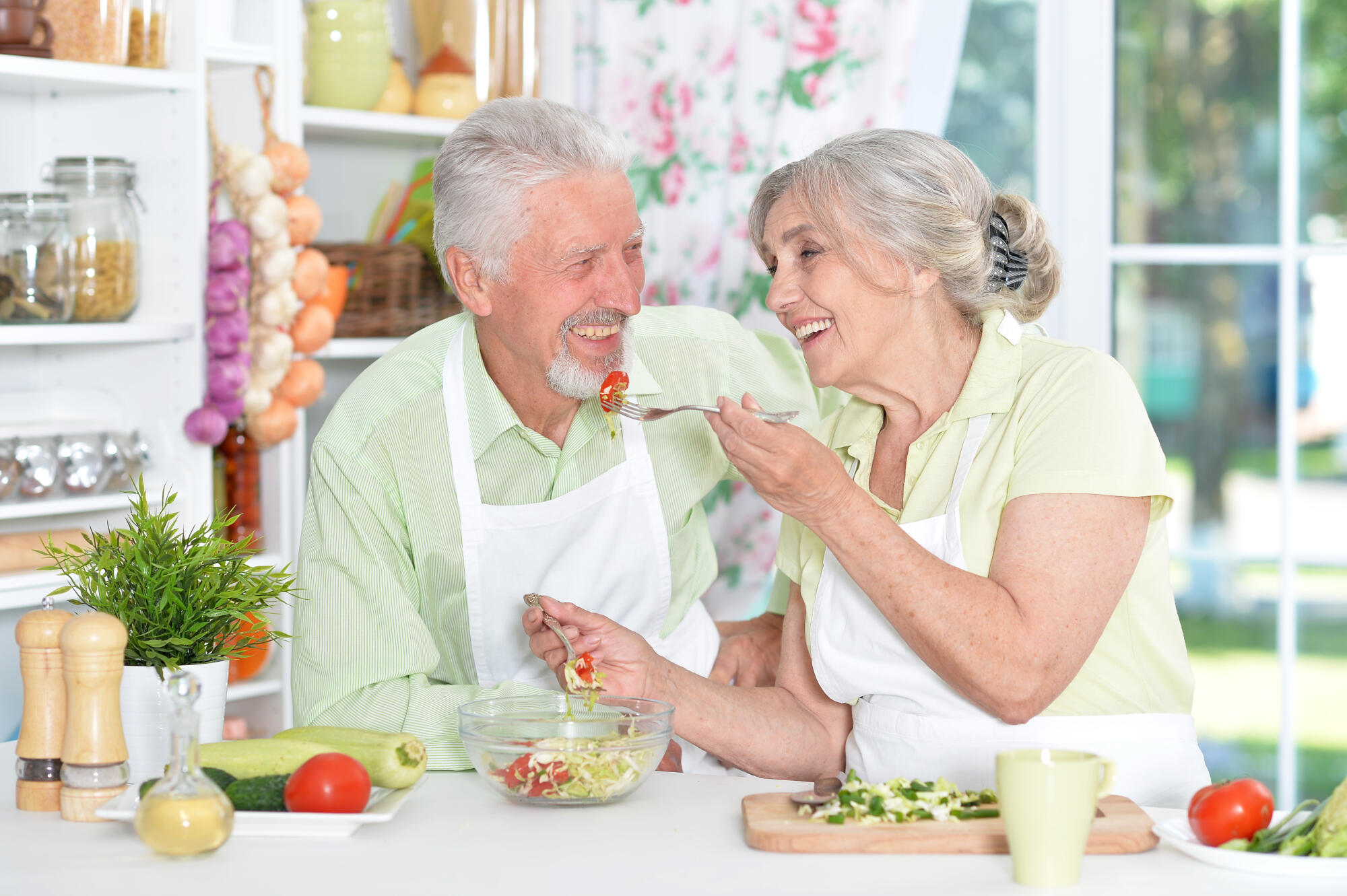 Portrait of a senior couple cooking in kitchen Portrait of a senior couple cooking in kitchen