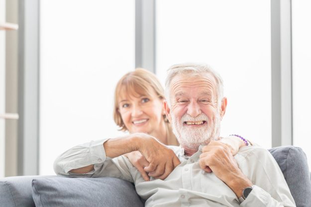 Portrait of happy senior couple in living room, Elderly man and Portrait of happy senior couple in living room, Elderly man and