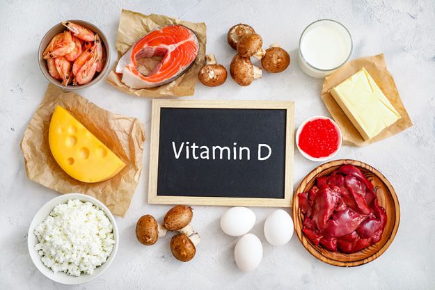 Assortment high vitamin sources white background milk liver prawns salmon Assortment high vitamin sources white background milk liver prawns salmon