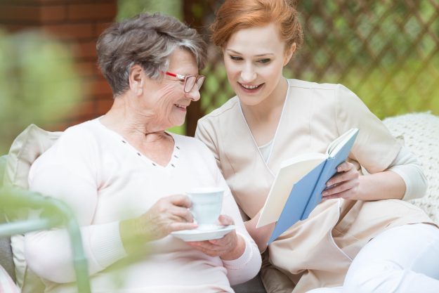 Happy,Grandma,In,Glasses,Holding,Cup,Of,Coffee,And,Watching Happy,Grandma,In,Glasses,Holding,Cup,Of,Coffee,And,Watching