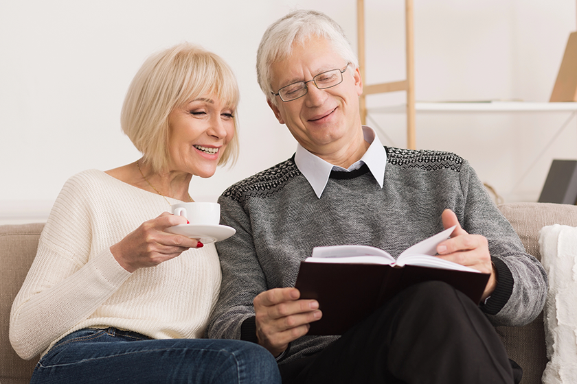 elder man showing illustration in book elder man showing illustration in book