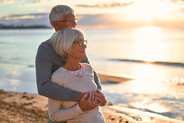 Elderly intelligent couple love spending time romantically beach sea walking Elderly intelligent couple love spending time romantically beach sea walking