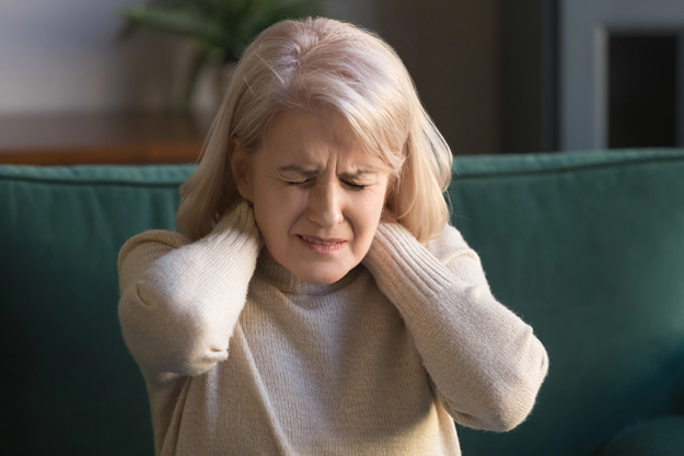 elderly woman feels unhealthy massaging neck